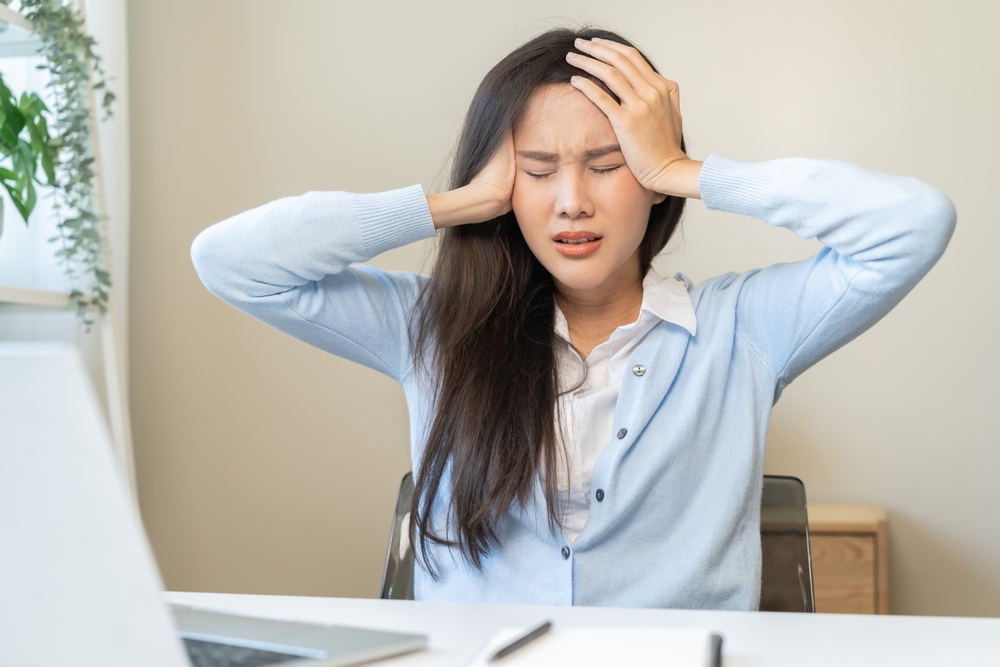 Stressed, exhausted asian young woman, girl pain from vertigo, having migraine symptoms headache, feel unhealthy, suffering from dizziness, holding head with hand. Health care problem of people.
