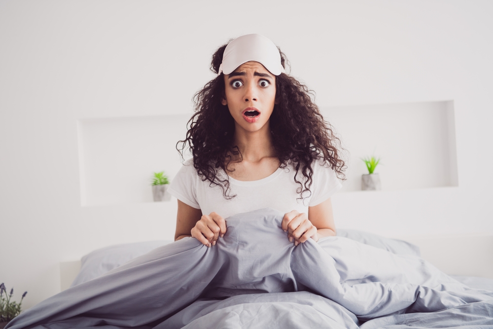 Photo of young attractive woman sit bed frightened nightmare wear stylish pajama soft comfy bedroom white room interior inside
